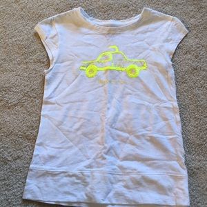 A white short sleeve shirt with a yellow taxi cab